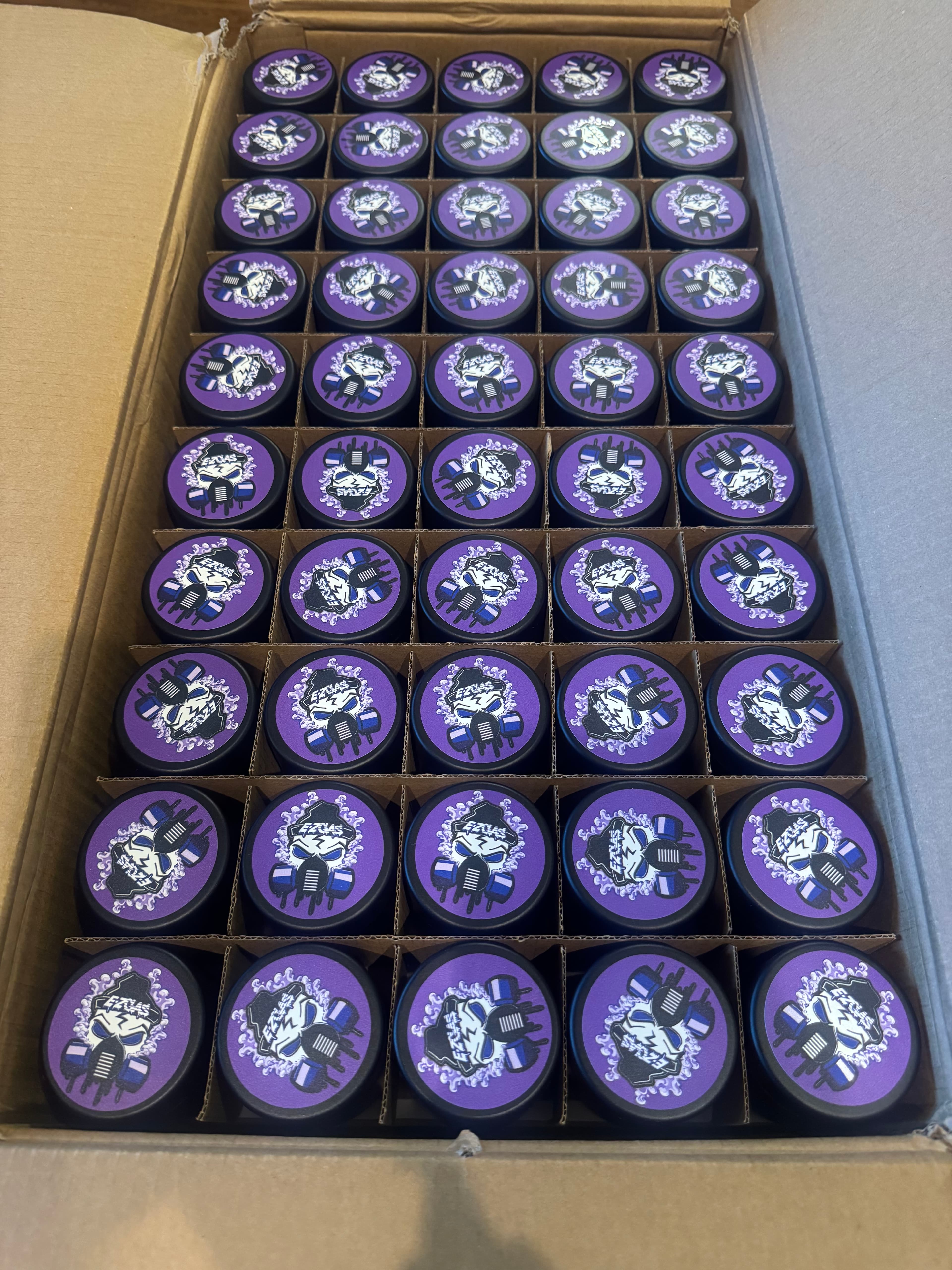 Box of branded purple grinder lids